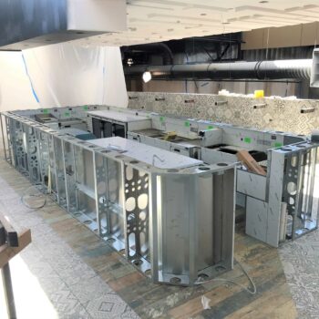 An unfinished bar with metal / aluminum frames exposed.